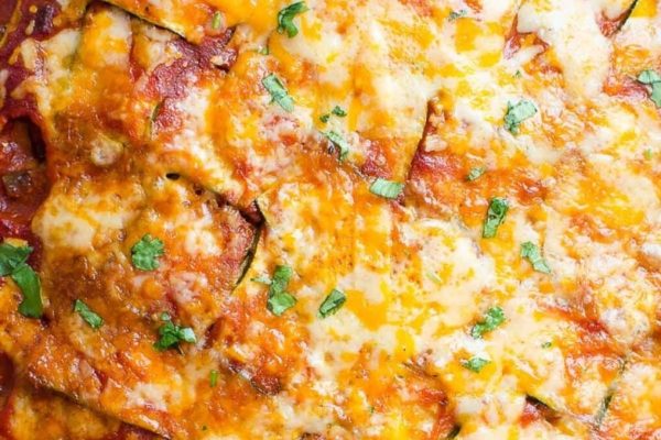 Cheesy zucchini enchiladas in a casserole dish.