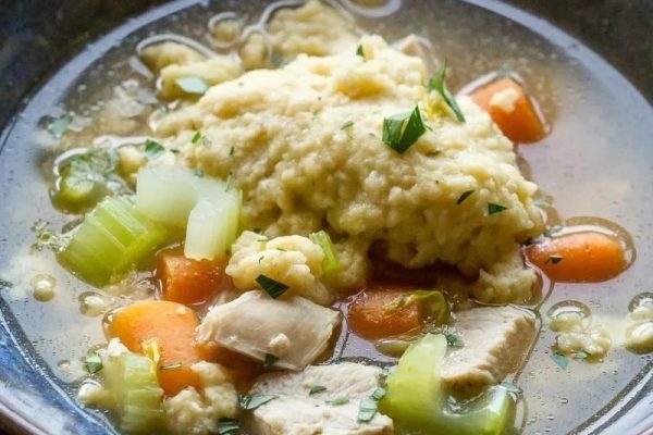 A classic bowl of soup with carrots and mashed potatoes.