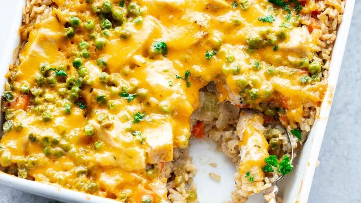 Chicken and rice casserole in a white casserole dish.