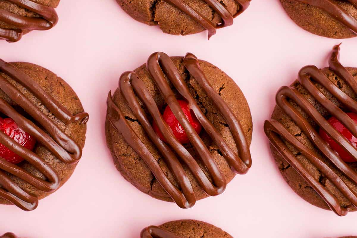 Chocolate thumbprint cookies with a cherry in the middle.
