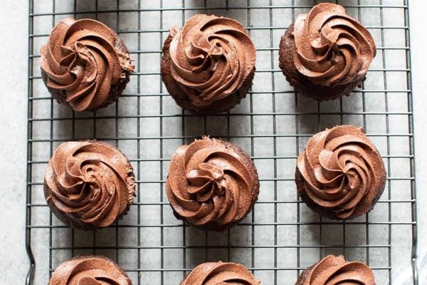 Christmas-themed cupcakes on a cooling rack.