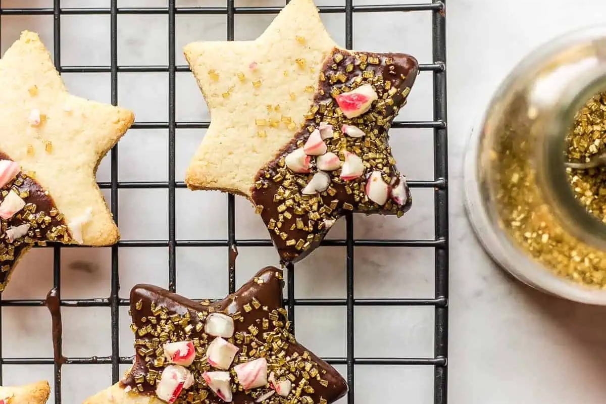 Candy cane flavored star cookies on a cooling rack.