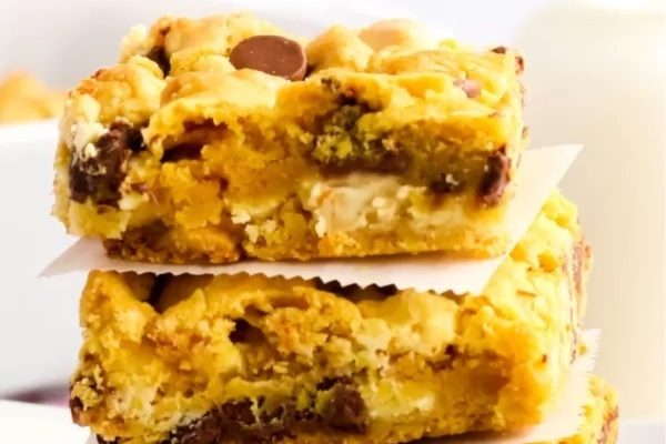 A stack of chocolate chip cookie bars on a plate.