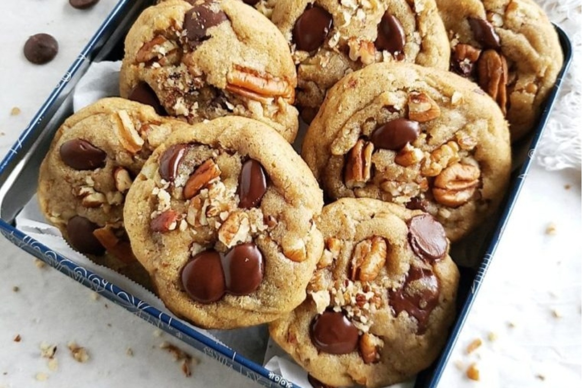 Chocolate pecan cookies in a blue tin.