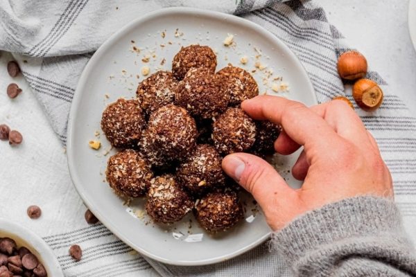 Chocolate hazelnut energy balls adorned on a plate.