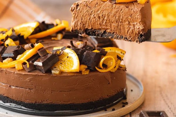 A delectable chocolate cake adorned with tangy orange slices.