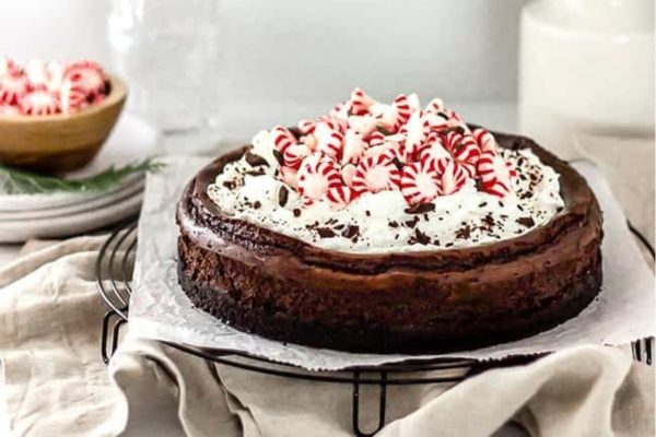 Chocolate peppermint cheesecake on a wire rack.