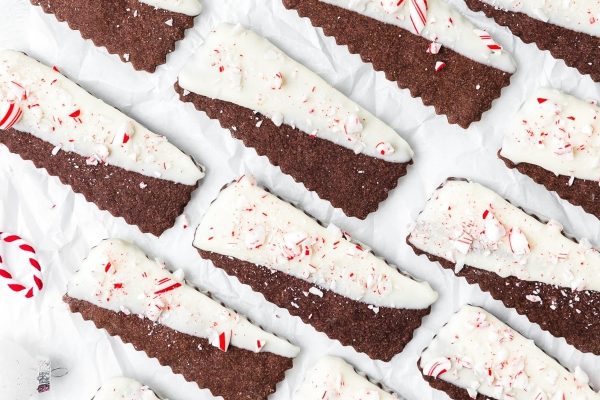 Christmas chocolate peppermint cookies with white icing and candy canes.