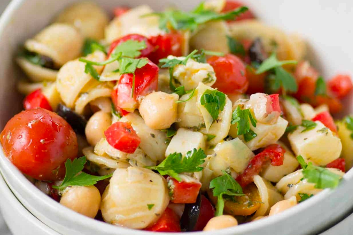 An Italian pasta salad with tomatoes and chickpeas, perfect as a side dish.