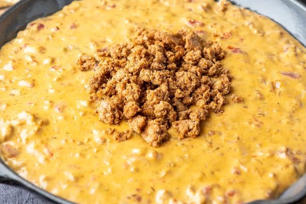 Chorizo dip in a cast iron skillet.