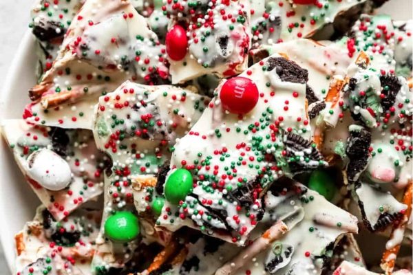 Christmas Oreo bark decorated with sprinkles and candy canes.