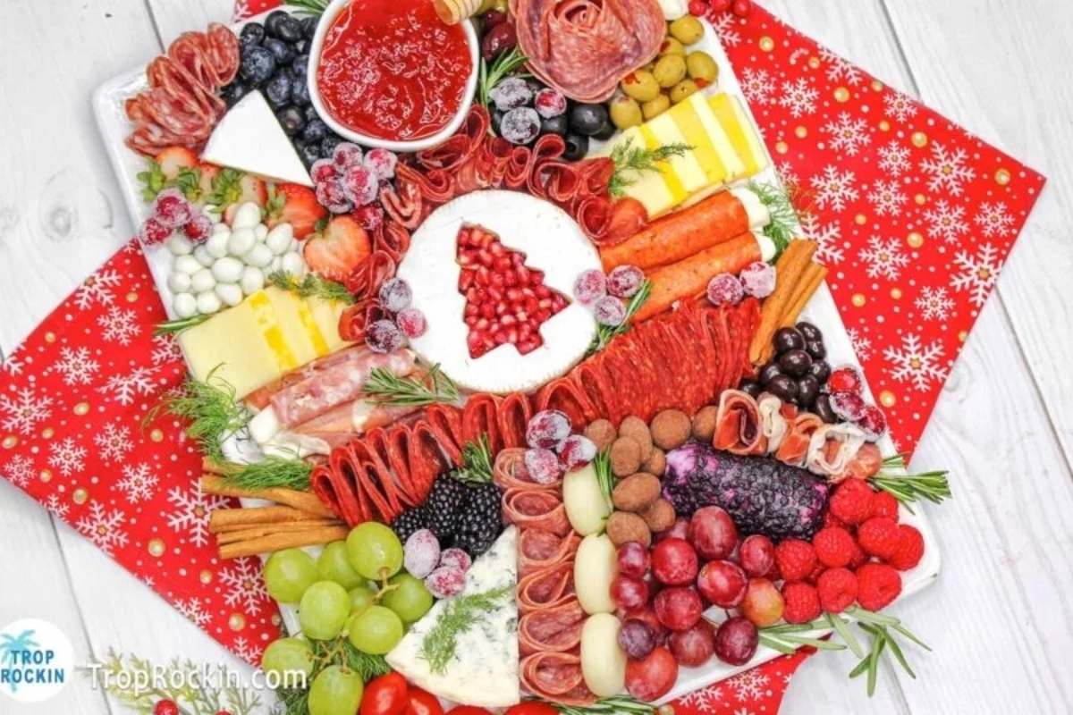 A festive charcuterie board for Christmas, showcasing an assortment of meats and cheeses.