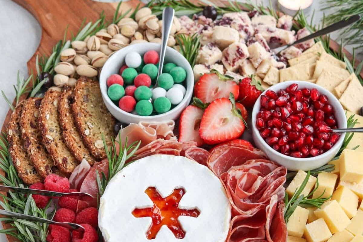 A festive Christmas charcuterie board filled with a variety of delightful foods.