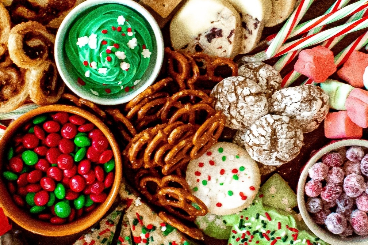 A variety of cookies and candy are arranged on a table.