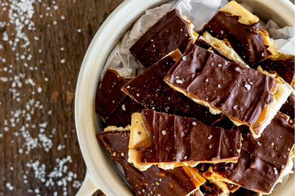 A white bowl filled with chocolate and sea salt.