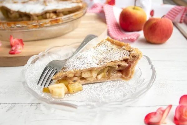 A slice of apple pie on a plate with a fork.