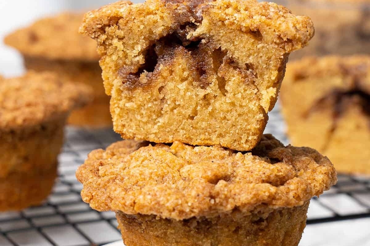 A stack of pumpkin muffins on a cooling rack, perfect for fall recipes.