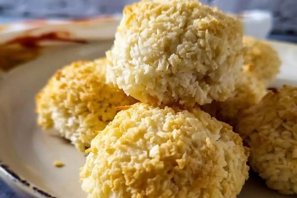 Coconut rice balls, a delightful dessert, arranged on a plate.