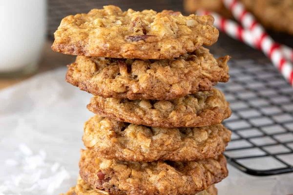 A stack of oatmeal cookies on a cooling rack.