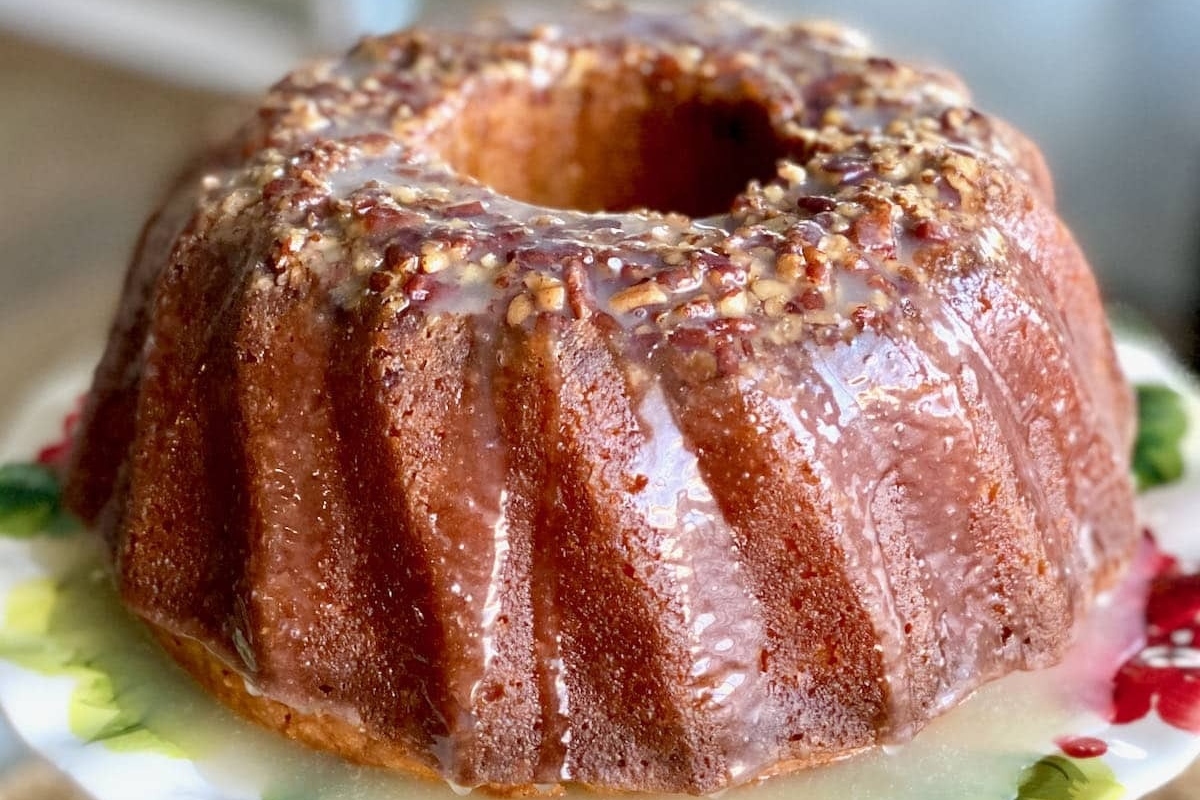 A delectable bundt cake decorated with a luscious icing and vibrant pomegranate seeds.