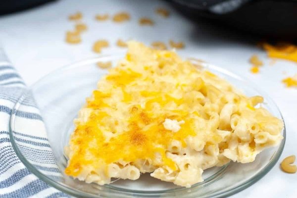 A slice of macaroni and cheese on a plate.
