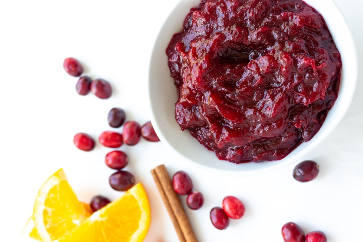Cranberry sauce recipe with oranges and cinnamon sticks.
