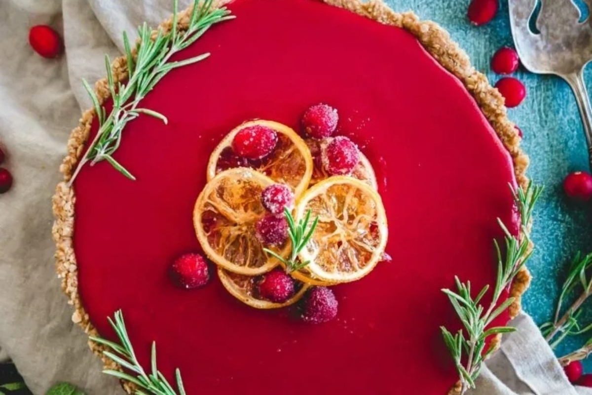 A Thanksgiving recipe featuring a red tart with cranberries and sprigs of rosemary.
