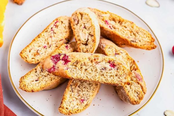 Cranberry almond biscotti with a hint of orange zest on a plate.