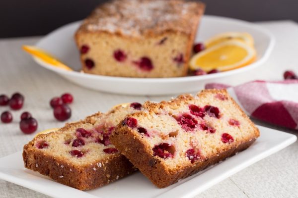 A slice of cranberry bread on a plate.
