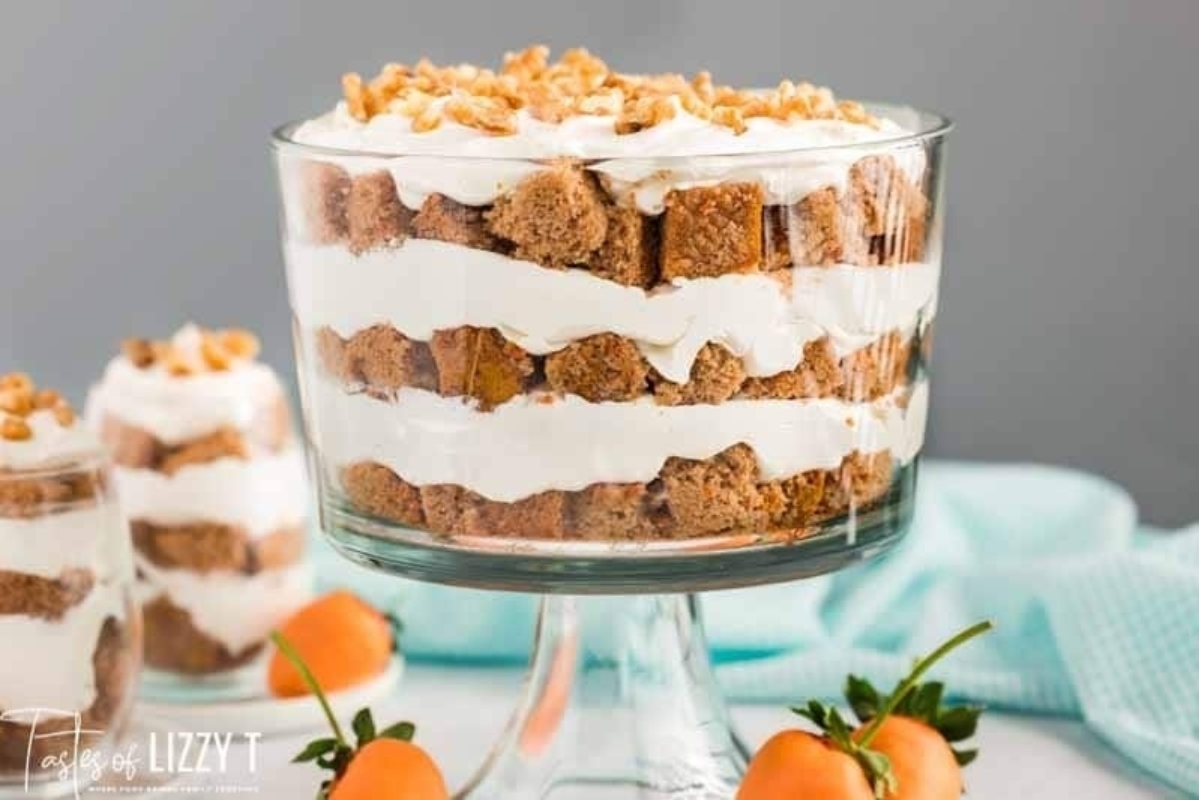 A delightful dessert, showcasing a combination of silky whipped cream and zesty oranges, served in an elegant glass bowl.