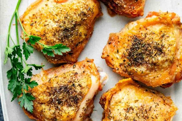 Chicken breasts on a white plate with parsley, perfect for parents looking for kid-friendly recipes.