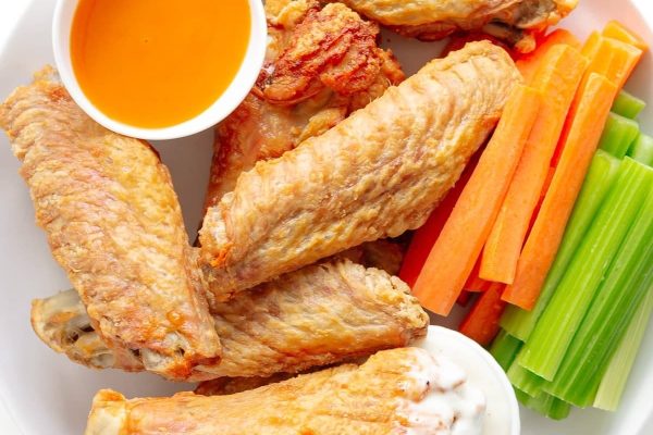 Game Day plate with chicken wings, carrots, celery and dip.