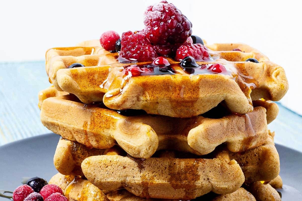 A stack of waffles with fresh berries and a drizzle of syrup for picky eaters.