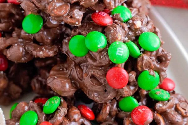 A stack of chocolate cereal krispy treats on a plate.