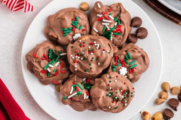 Chocolate covered cookies on a white plate.