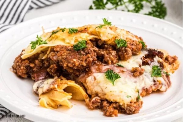 A plate of lasagna with meat and cheese on it.