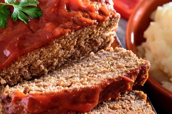 Meatloaf and mashed potatoes on a plate.