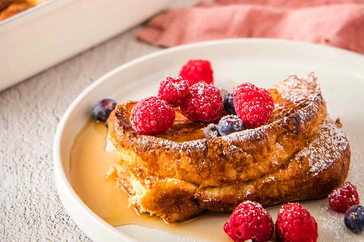         Description: A plate of french toast topped with berries and syrup, perfect for brunch.