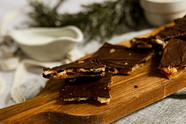 Chocolate bark on a wooden cutting board.