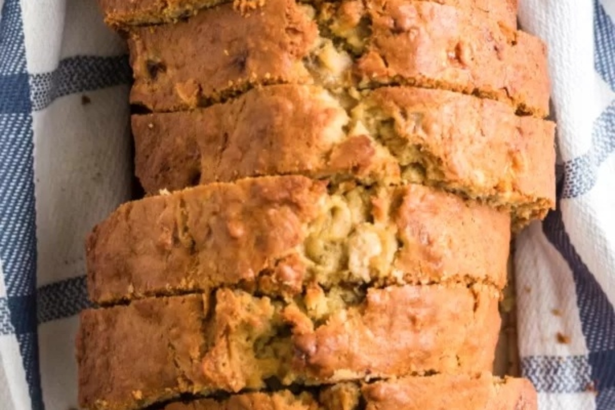 A delicious loaf of banana bread on a blue and white plate.