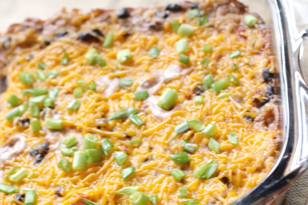 Cheesy black bean casserole in a glass dish.