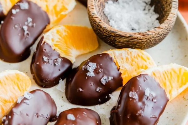 Chocolate covered orange slices on a plate.