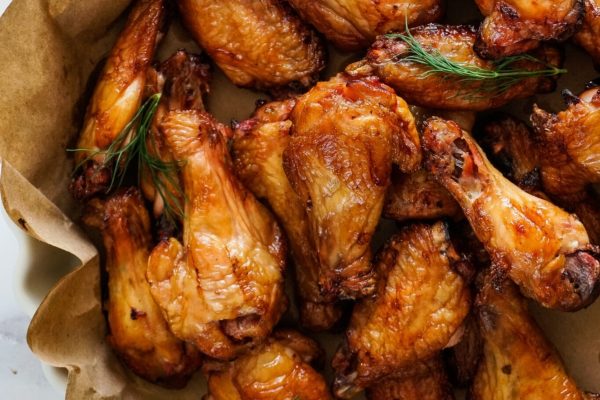 Game Day wings in a paper bag with sprigs of dill.
