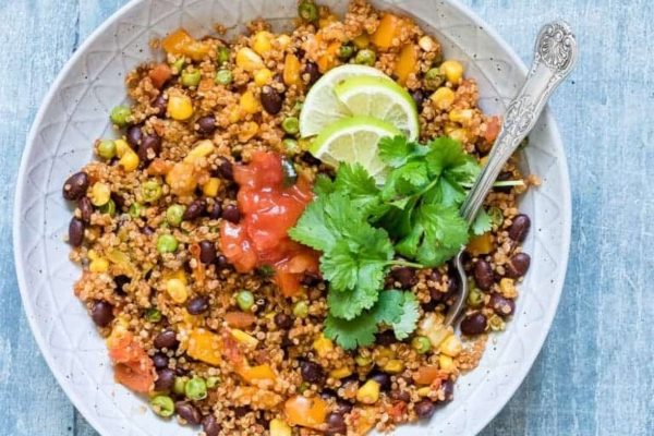A bowl of mexican quinoa with black beans and corn.