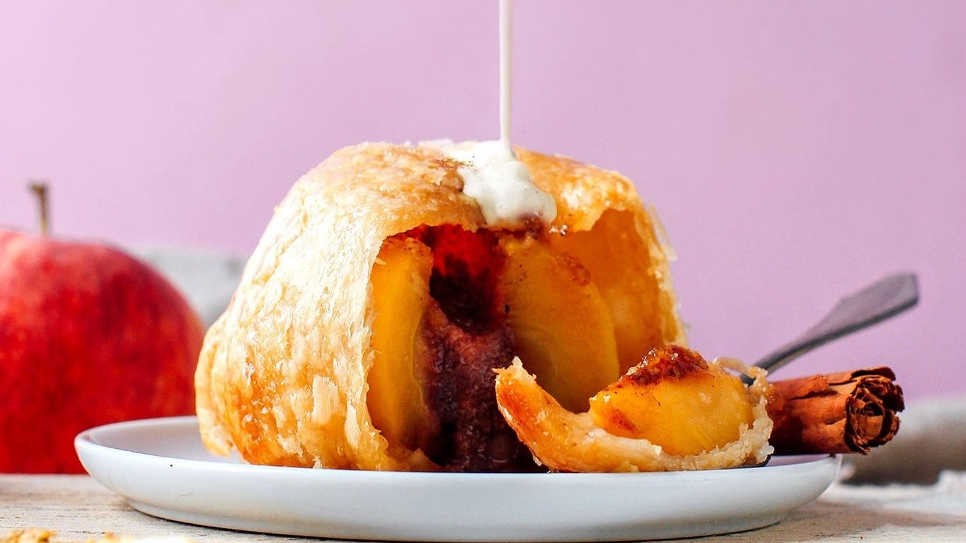 Dutch apple dumpling poured with milk.
