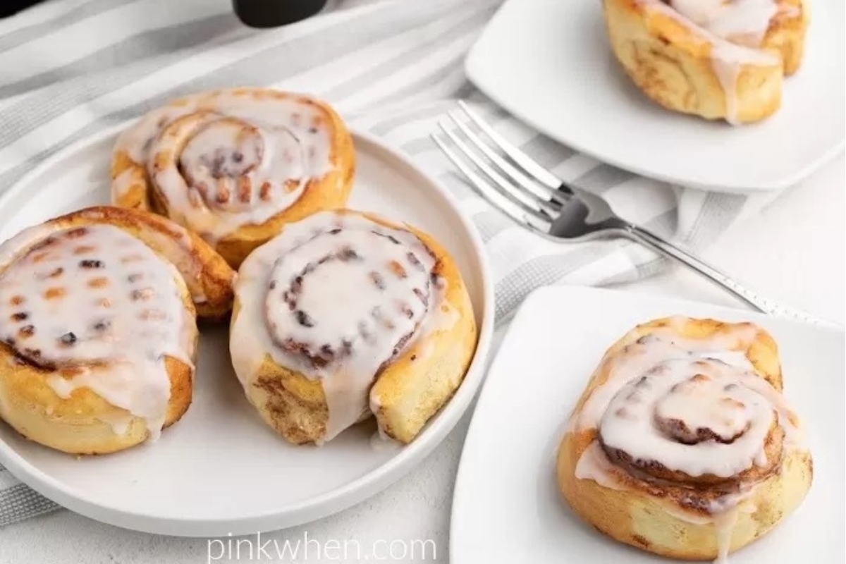 Cinnamon rolls with icing on a plate.
