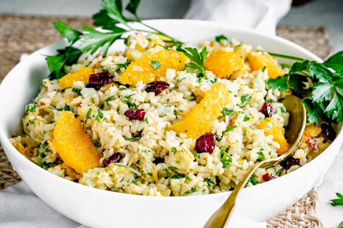 A festive bowl with orange rice and cranberries, perfect for Thanksgiving make ahead recipes.