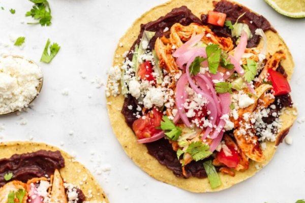 Mexican chicken tacos on a white background.