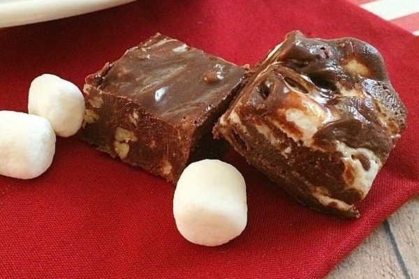 A piece of chocolate fudge with marshmallows on top.