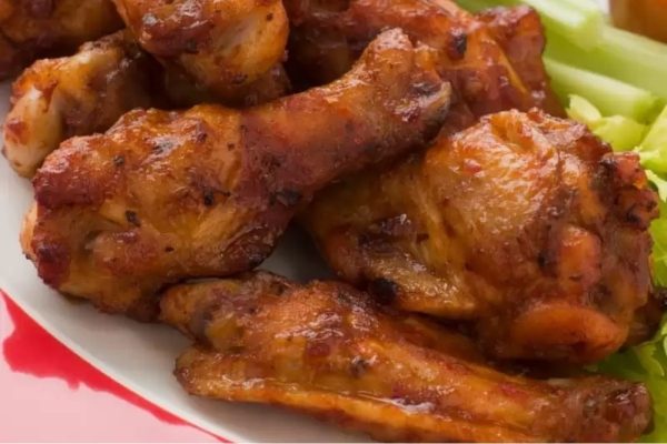 Game Day wings with BBQ chicken, served on a red plate.